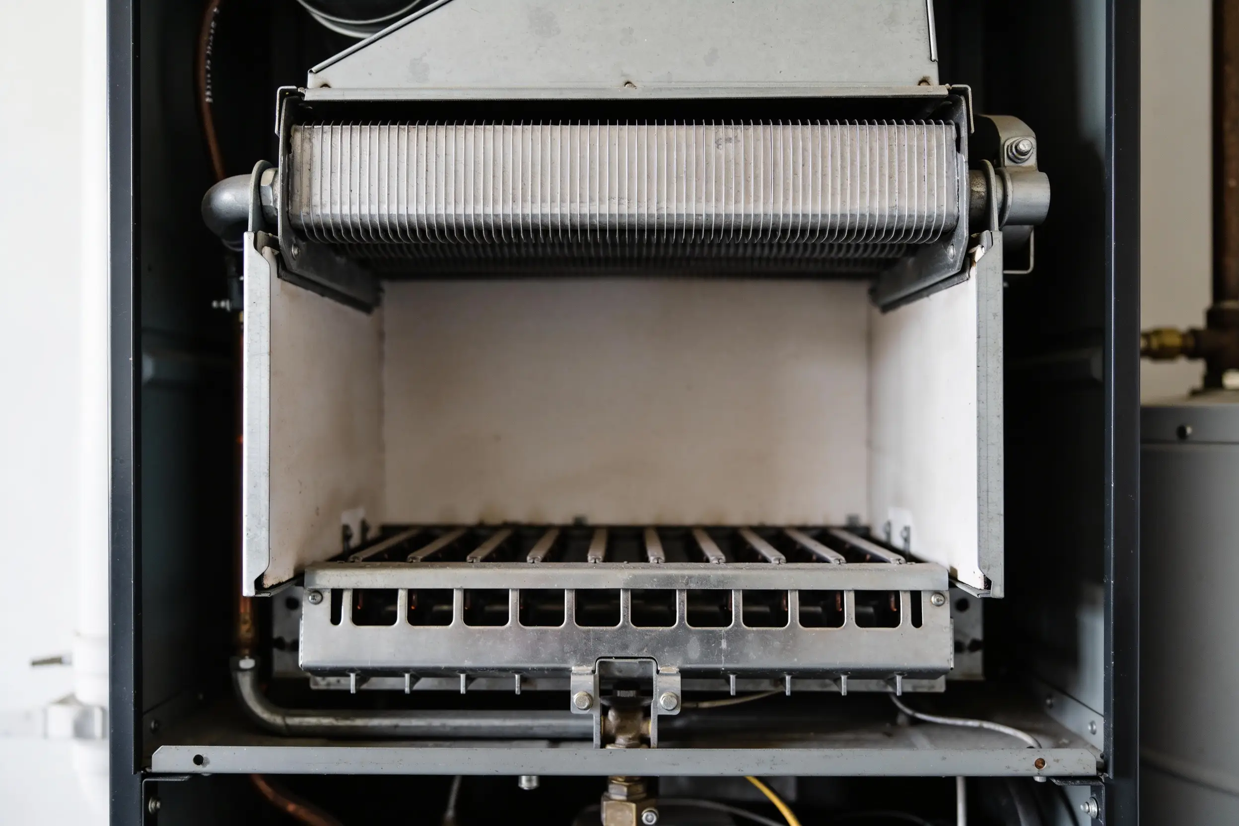 Open furnace cabinet showing the burner assembly and heat exchanger